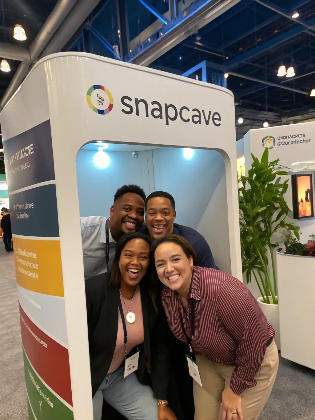A diverse group of people using the photo booth at a corporate event, showcasing the booth's versatility and appeal to different demographics.